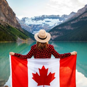 Woman holding Canadian flag outdoors